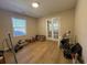 Spacious room featuring wood floors, lots of natural light, and French doors to another room at 10 Buckthorn St., Andrews, SC 29510