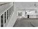 Living room with stairs, carpet, and view into kitchen at 101 Bent Tree Ln., Pawleys Island, SC 29585