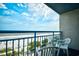 Enjoy ocean views from this balcony with white chairs at 1105 S Ocean Blvd. # 516, Myrtle Beach, SC 29577