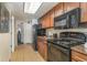 Galley kitchen with black appliances and wood cabinets at 1105 S Ocean Blvd. S # 1236, Myrtle Beach, SC 29577