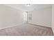 Cozy bedroom with neutral carpet, white trim, light-colored walls, and one window at 112 Lakota Loop, Longs, SC 29568