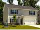 Charming two-story home featuring a well-maintained lawn and attached two-car garage at 112 Lakota Loop, Longs, SC 29568