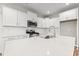 Bright kitchen features white cabinets, stainless steel appliances, and a large island at 112 Lakota Loop, Longs, SC 29568
