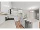 Bright kitchen featuring white cabinets, stainless steel appliances, and island with sink at 112 Lakota Loop, Longs, SC 29568