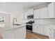 Bright kitchen features white cabinets, stainless steel appliances, and a large island at 112 Lakota Loop, Longs, SC 29568