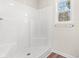 Clean shower with white walls, new shower head, and window for natural light at 112 Lakota Loop, Longs, SC 29568