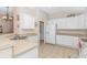 Bright kitchen with white cabinets, ample counter space, and tile flooring at 113 Barn Owl Ct., Carolina Shores, NC 28467