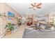 Open and bright living room with grey sectional sofa and hardwood floors at 113 Barn Owl Ct., Carolina Shores, NC 28467