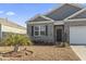 Gray siding and brick front of house with a landscaped yard at 1164 Maxwell Dr., Little River, SC 29566