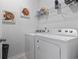 Bright laundry room, complete with washer, dryer, and shelving at 1164 Maxwell Dr., Little River, SC 29566