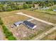 Aerial view of home showing gravel driveway, detached storage, and surrounding property at 122 Willie Mays Pl., Aynor, SC 29511