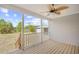 Covered back porch features wood flooring, white railings, and a view of the backyard at 122 Willie Mays Pl., Aynor, SC 29511