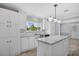 Bright kitchen with island, stainless steel appliances, white cabinets, and a window overlooking the outdoors at 122 Willie Mays Pl., Aynor, SC 29511