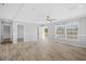 Spacious, neutral living room featuring wood-look flooring and natural light at 122 Willie Mays Pl., Aynor, SC 29511