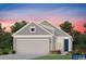 Exterior elevation of a single-Gathering home with gray siding, white trim, a dark blue front door, and a two-car garage at 1245 Lady Bird Way, North Myrtle Beach, SC 29582