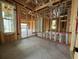 Interior framing of a room with exposed studs, windows, and a ladder at 1245 Lady Bird Way, North Myrtle Beach, SC 29582