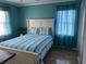 Bedroom with striped bedding and teal walls at 130 Easy St., Murrells Inlet, SC 29576