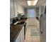 Galley kitchen with white cabinets and dark countertops at 130 Easy St., Murrells Inlet, SC 29576