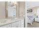 Bathroom with white vanity and large mirror at 1303 S Ocean Blvd., North Myrtle Beach, SC 29582