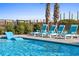 Inviting pool with lounge chairs and palm trees at 1303 S Ocean Blvd., North Myrtle Beach, SC 29582