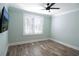 Bedroom with hardwood floors, plantation shutters, and mounted TV at 132 Serenity Point Dr., Little River, SC 29566