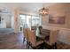 Casual dining area with dark wood table, neutral chairs, and sliding doors at 132 Serenity Point Dr., Little River, SC 29566