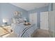 Guest bedroom with a striped comforter and closet at 1334 Palm Springs Paloma Dr, Longs, SC 29568