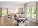 Bright dining area with round table and four chairs, adjacent to living room at 1349 Palm Springs Paloma Dr, Longs, SC 29568