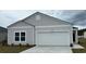 One-story home with gray siding and a two-car garage at 1349 Palm Springs Paloma Dr, Longs, SC 29568