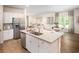 Kitchen with island, stainless steel appliances, and white cabinets at 1349 Palm Springs Paloma Dr, Longs, SC 29568