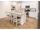 White kitchen with granite countertops and island with seating at 1349 Palm Springs Paloma Dr, Longs, SC 29568