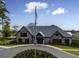 Community clubhouse with stone exterior and flagpole at 1420 Jardine Loop, Little River, SC 29566