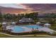 Community pool with clubhouse and surrounding landscape at sunset at 1420 Jardine Loop, Little River, SC 29566