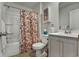 Bathroom with floral shower curtain, tub, and single vanity at 1454 Jardine Loop, Little River, SC 29566