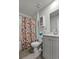 Simple bathroom with a floral shower curtain, toilet, and vanity at 1454 Jardine Loop, Little River, SC 29566