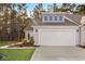 Front exterior of house with garage and landscaping at 1454 Jardine Loop, Little River, SC 29566