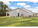 Rear exterior view of house showcasing patio and lawn at 1454 Jardine Loop, Little River, SC 29566