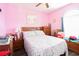 Bedroom with pink walls, starfish bedding, and a wooden dresser at 149 Westhaven Dr. # B13, Myrtle Beach, SC 29579