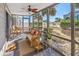 Relaxing screened porch with wicker furniture, ceiling fan, and ocean view at 1820 N Ocean Blvd. # 102D, North Myrtle Beach, SC 29582