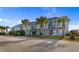 Front view of townhouses with palm trees and a paved road at 1851 Colony Dr. # 5E, Surfside Beach, SC 29575