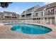 Kidney shaped pool with surrounding lounge chairs at 1851 Colony Dr. # 5E, Surfside Beach, SC 29575