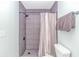 Clean shower with gray tile and a shower curtain at 19 Springfield Rd., Pawleys Island, SC 29585