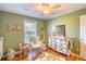 Charming Bedroom with crib, rocking chair, and jungle theme at 1900 Allston St., Georgetown, SC 29440