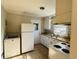 Galley kitchen with white cabinets and appliances at 1916 Calhoun St., Georgetown, SC 29440