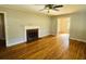 Living room with hardwood floors, fireplace, and ceiling fan at 1916 Calhoun St., Georgetown, SC 29440