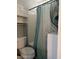 Bathroom with a toilet, bathtub, and peacock-themed shower curtain at 1925 Bent Grass Dr. # B, Surfside Beach, SC 29575