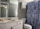 Bathroom with white vanity, toilet, and seashell shower curtain at 1925 Bent Grass Dr. # B, Surfside Beach, SC 29575