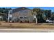 Two-story building exterior, featuring gray siding and landscaping at 1925 Bent Grass Dr. # B, Surfside Beach, SC 29575