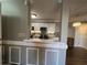 Partial view of a kitchen featuring white cabinets, stainless steel appliances, and a tile backsplash at 1925 Bent Grass Dr. # B, Surfside Beach, SC 29575