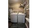 Stackable washer and dryer in this laundry room with shelving at 1925 Bent Grass Dr. # B, Surfside Beach, SC 29575